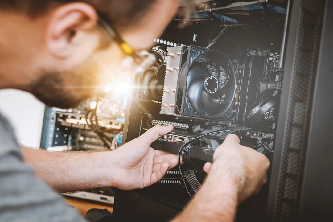 Technician working inside a desktop computer at DriveTech
